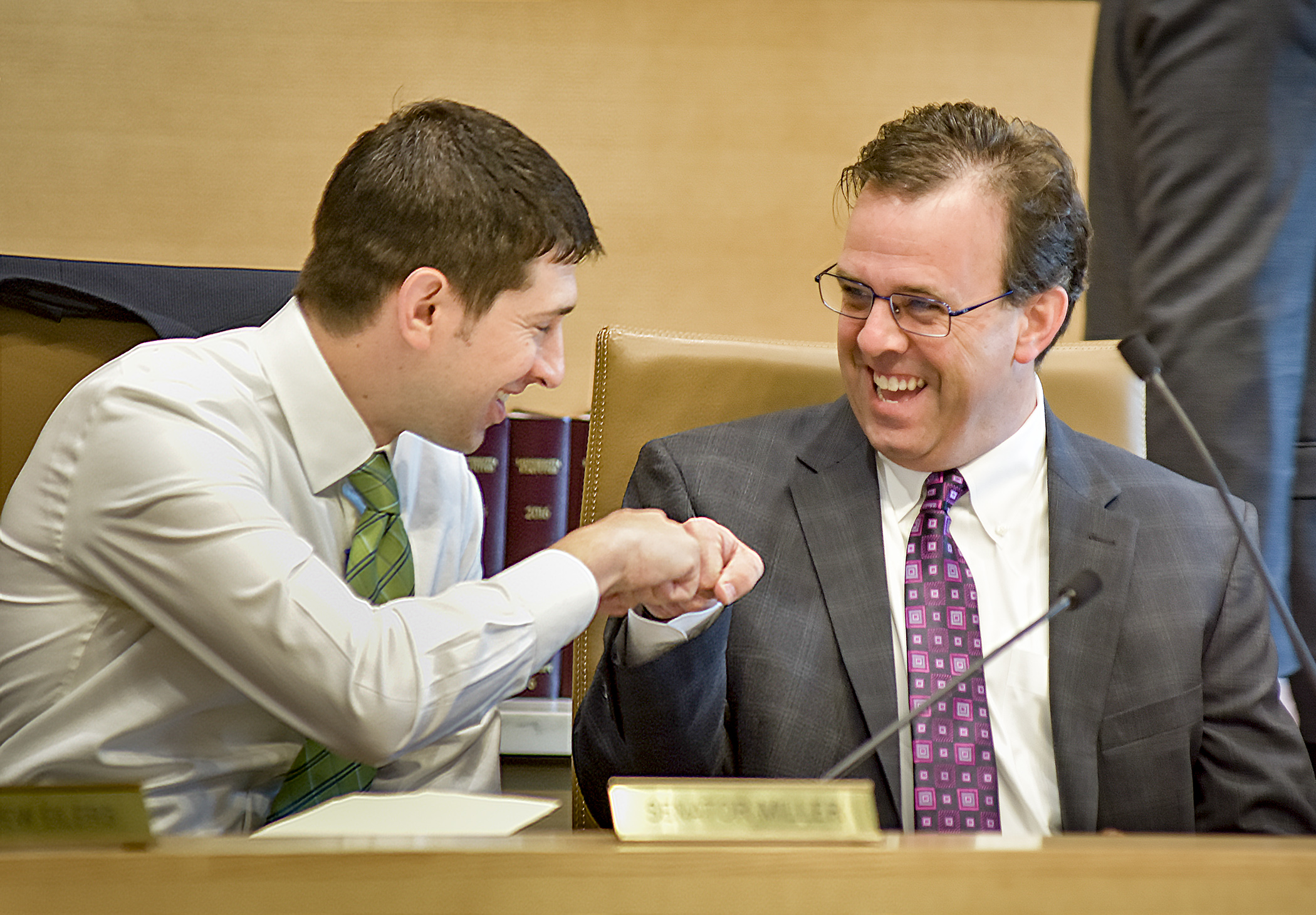 Sen. Jeremy Miller, left, and Rep. Pat Garofalo, co-chairs of the omnibus jobs and energy conference committee, fist bump before a May 9 meeting. Photo by Andrew VonBank